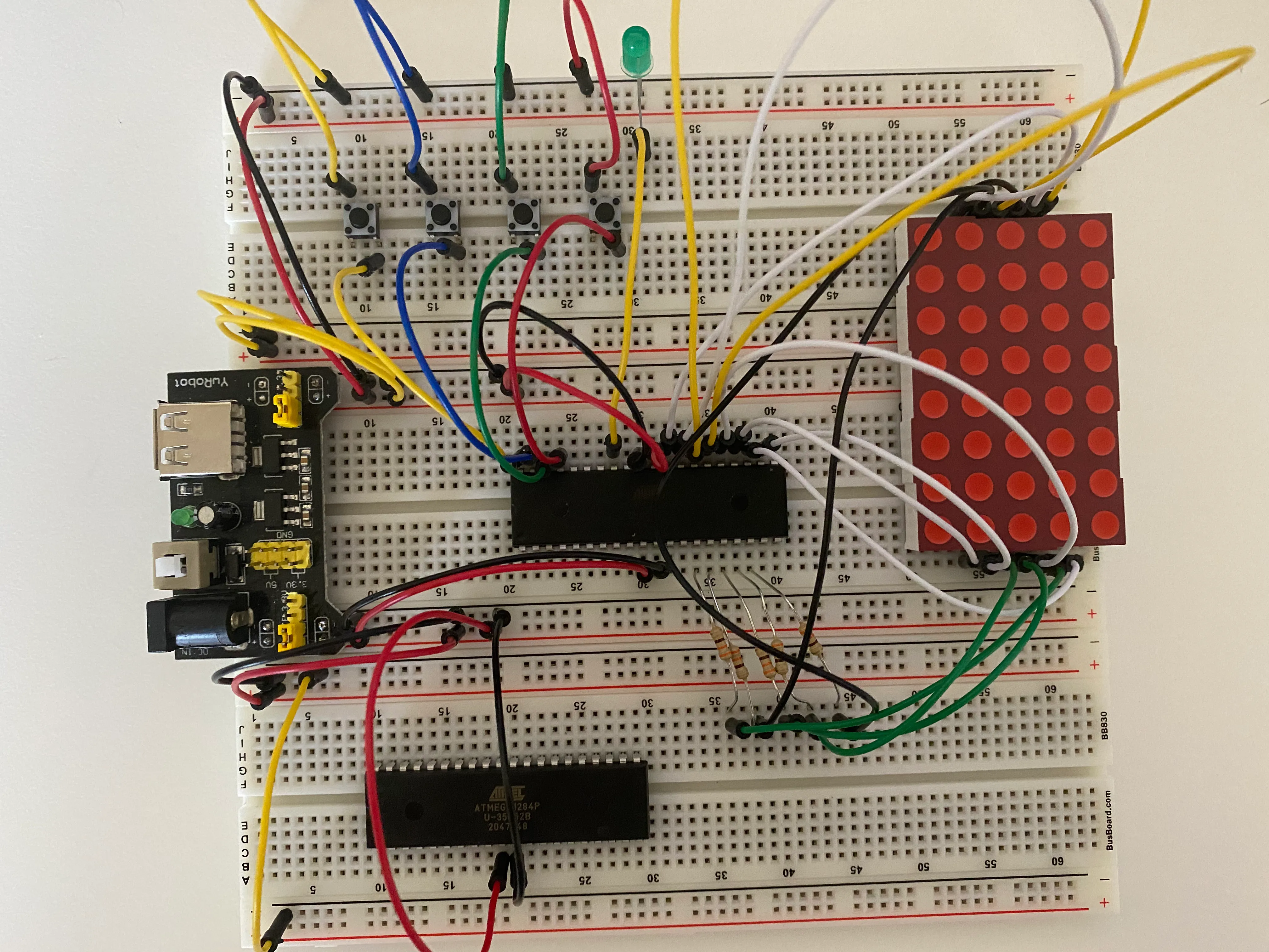 A breadboard with a microcontroller and LED matrix