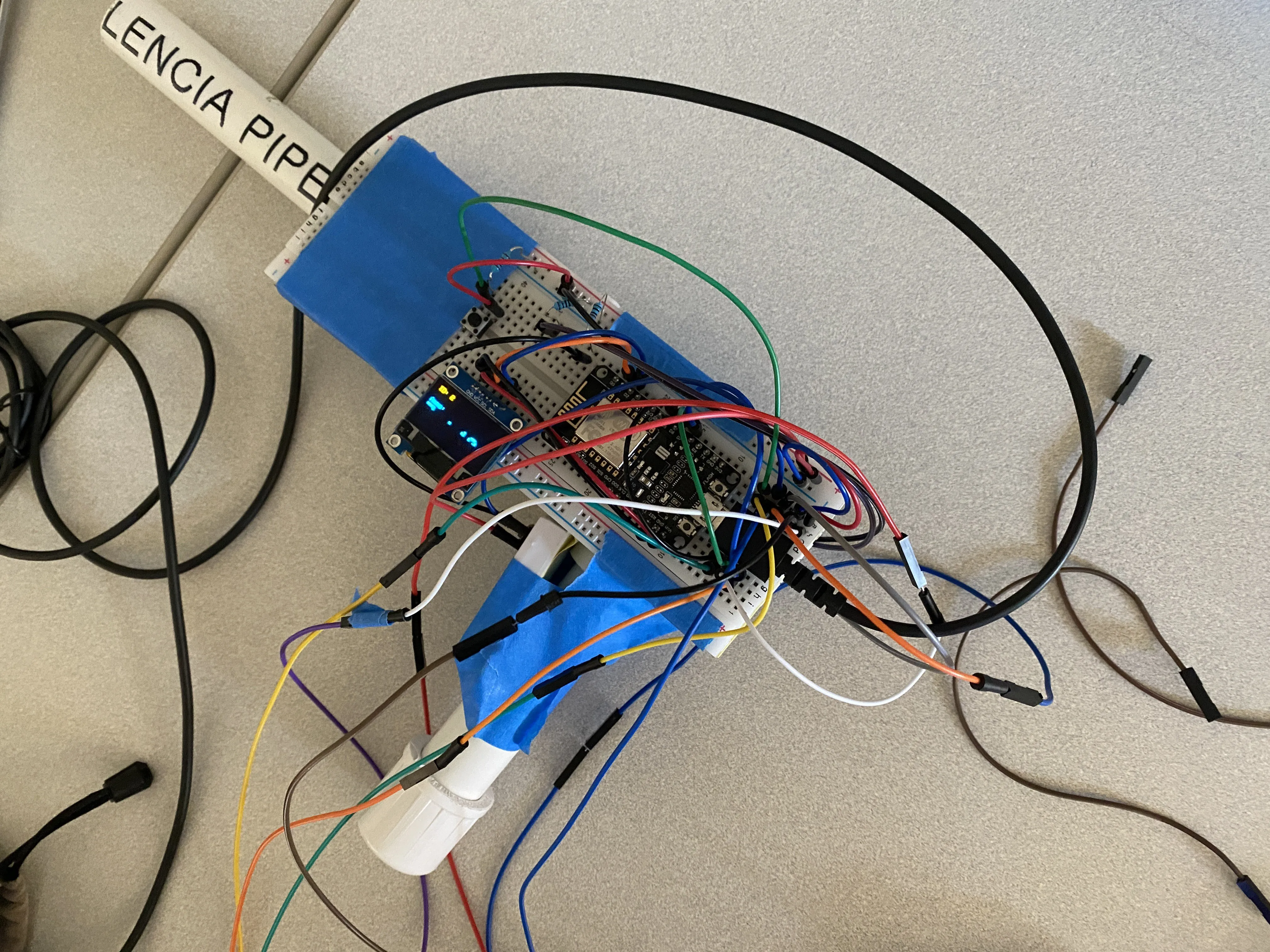 A PVC pipe joint taped with an electronic breadboard